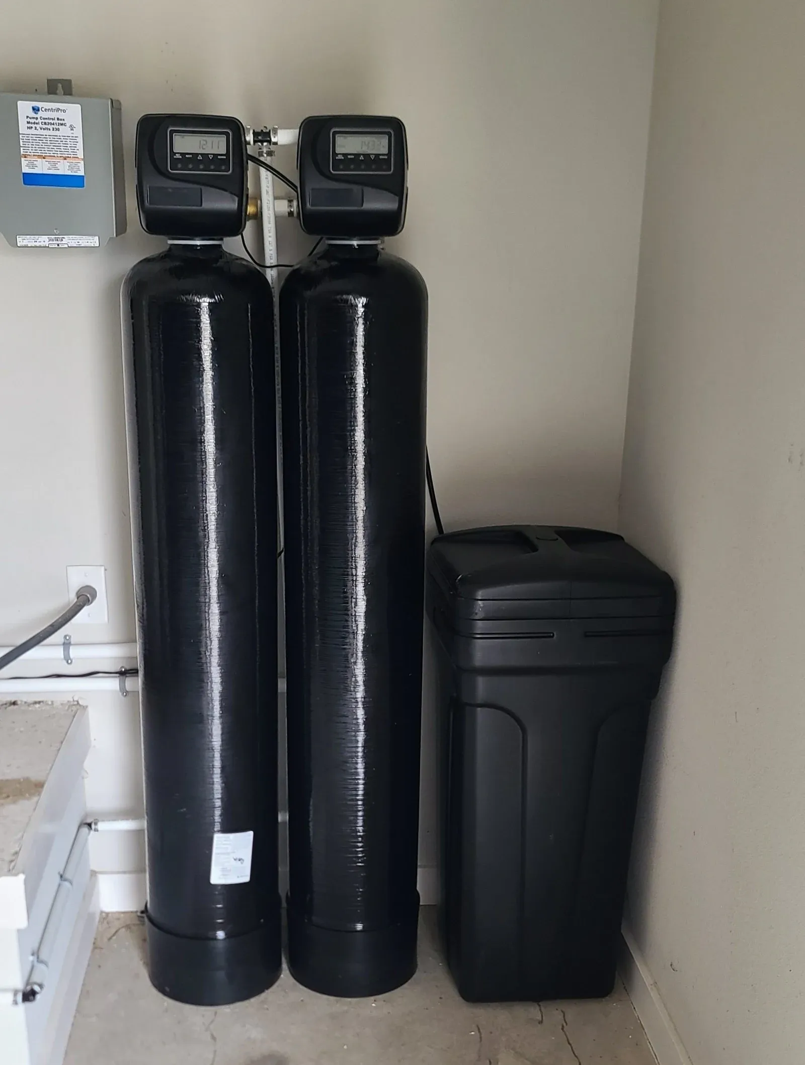 BluePeak Iron Breaker AIO well system in Holly Springs: two tanks, each with its own control valve, and a brine tank