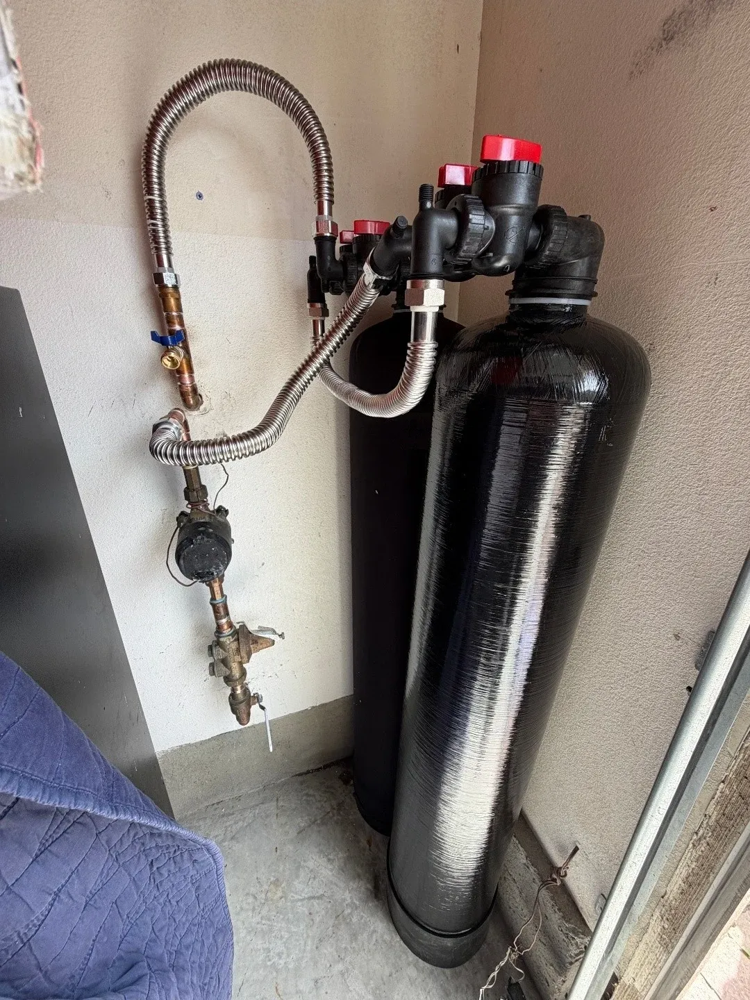 BluePeak Salt-Free Conditioner tank plumbed in with braided steel lines in a Fuquay-Varina garage