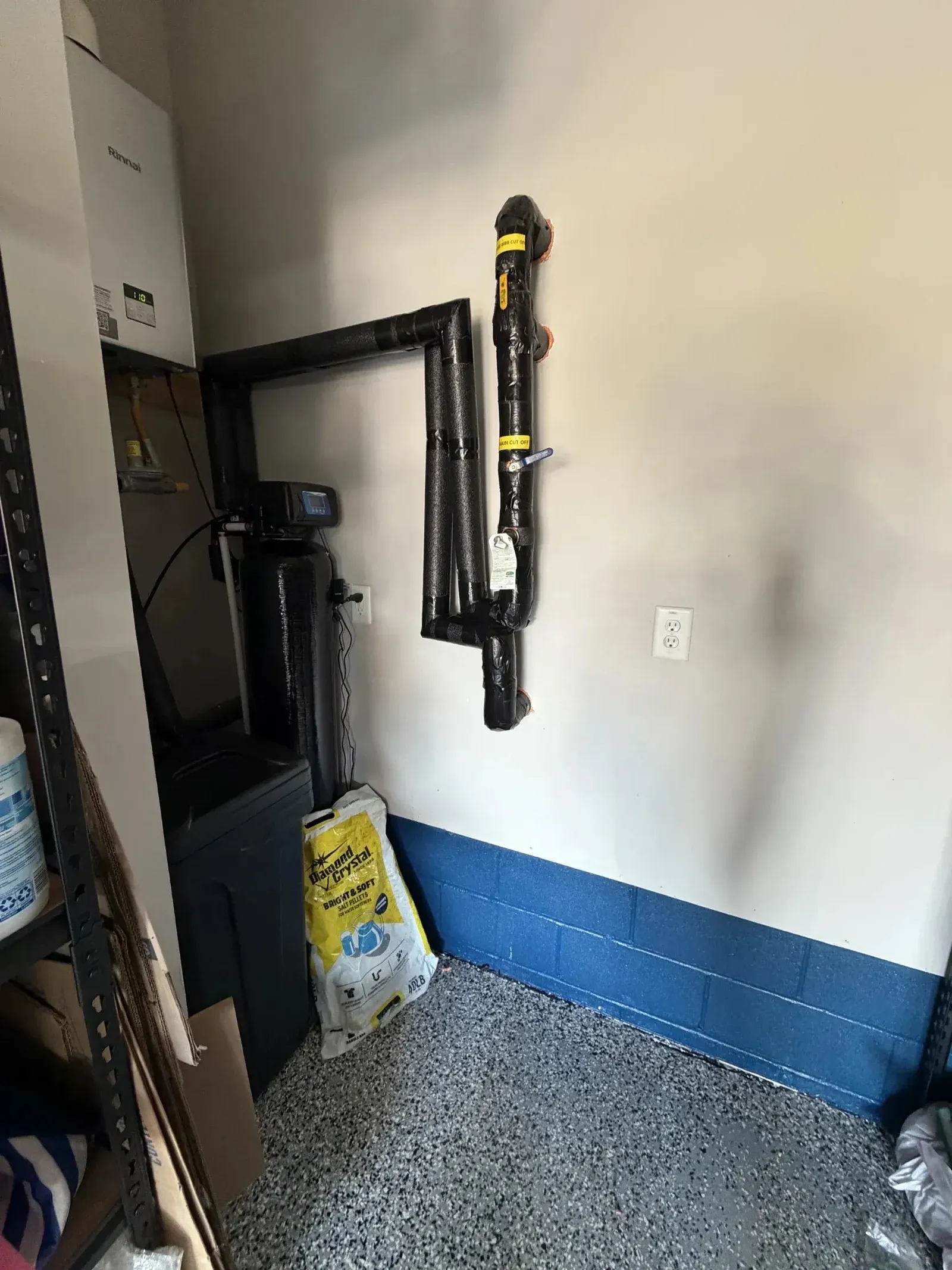BluePeak Softener Only system and brine tank plumbed into the main line in an Apex garage